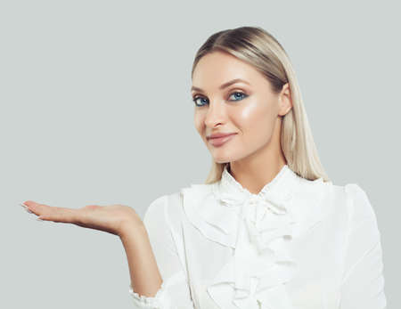 Perfect business woman showing empty open hand on white background. Businesswoman smiling, business and education conceptの写真素材