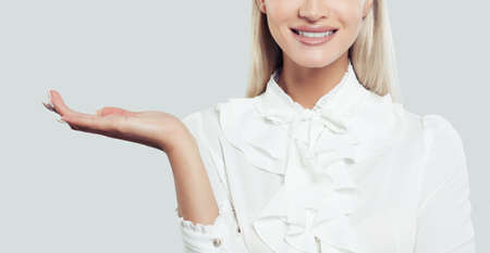 Empty open hand of business woman. Advertising marketing or product placement conceptの写真素材