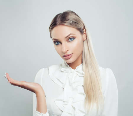 Business woman showing empty open hand on white background. Businesswoman smiling, business and education conceptの写真素材