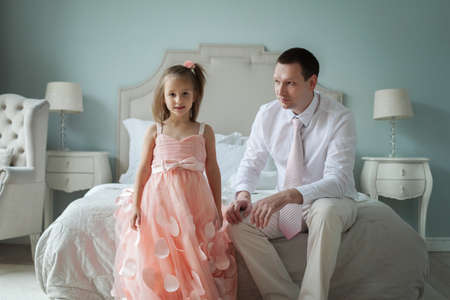 Father and young daughter together at homeの写真素材