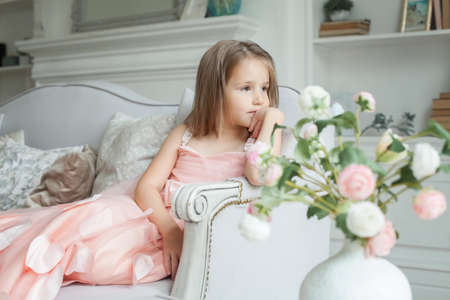 Bored child girl at homeの写真素材