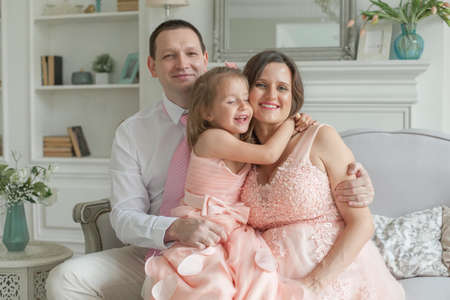 Happy family mother, father, child daughter at homeの写真素材