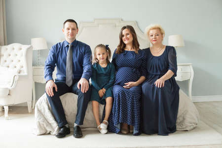 Portrait of happy family. Smiling mother, daughter, father and grandmother at homeの写真素材