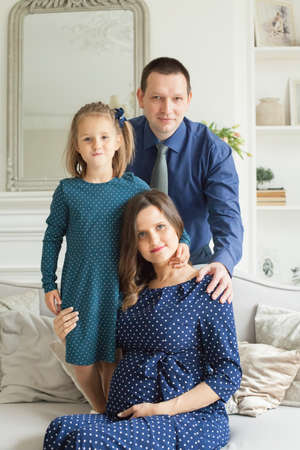 Happy family - mother, father, child daughter at homeの写真素材