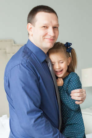 Happy daughter with father at homeの写真素材