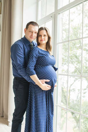 Happy pregnant couple at homeの写真素材