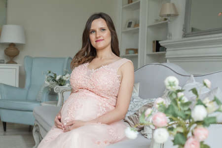 Pregnant woman resting at home. Pregnancy, maternity, preparation and expectation conceptの写真素材