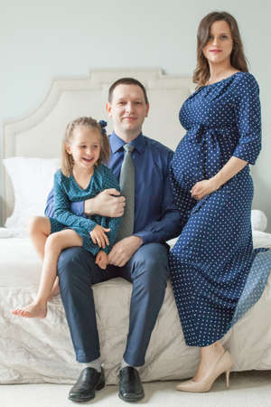 Portrait of happy family. Mother, father, child daughter at homeの写真素材