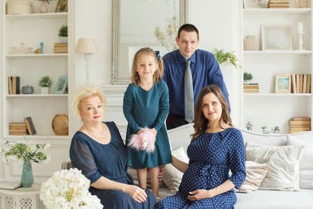 Happy family generation. Happy mother, daughter, father and grandmother at homeの写真素材