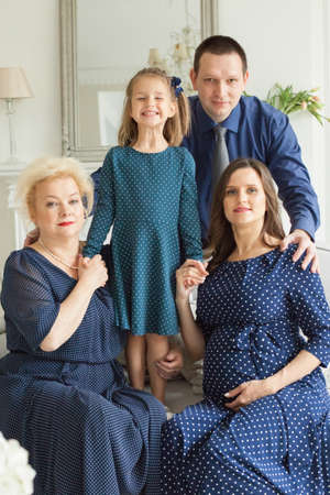 Happy family portrait. Smiling mother, daughter, father and grandmother at homeの写真素材