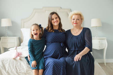 Grandmother, adult daughter and little granddaughter. Happy family portraitの写真素材