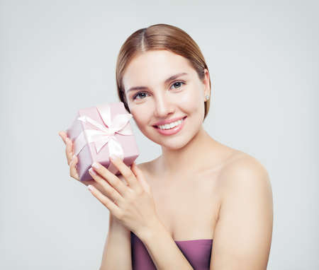 Pretty woman with gift on white backgroundの写真素材