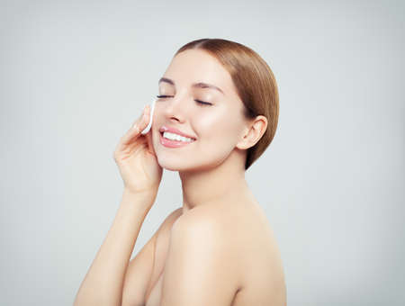 Cotton pad woman face, cosmetology remover makeup and clean skin conceptの写真素材
