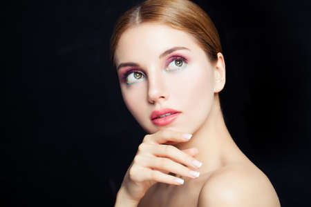 Glamorous woman portrait. Pretty girl with colorful makeup on black background, portraitの写真素材