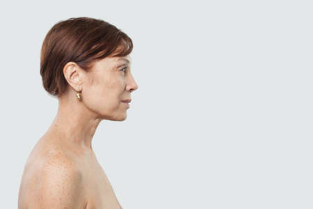 Mid adult woman face on whiteの写真素材