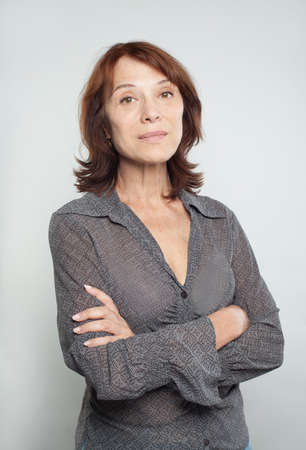 Mature business woman with crossed arms, portraitの写真素材