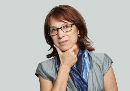 Thinking business woman in glasses on whiteの写真素材