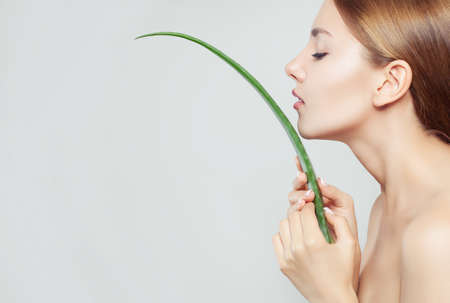 Healthy woman with clear skin and aloe leafの写真素材