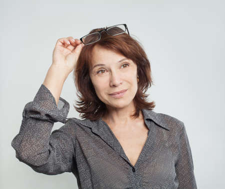 Cute mature business woman with glasses, portraitの写真素材