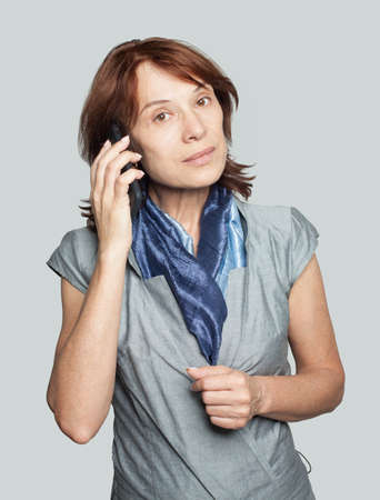 Mature woman phone. Businesswoman cell phoneの写真素材