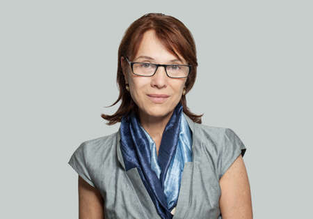 Portrait of mature business woman in blue scarfの写真素材
