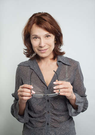 Cheerful mature woman with glasses. Businesswoman smilingの写真素材