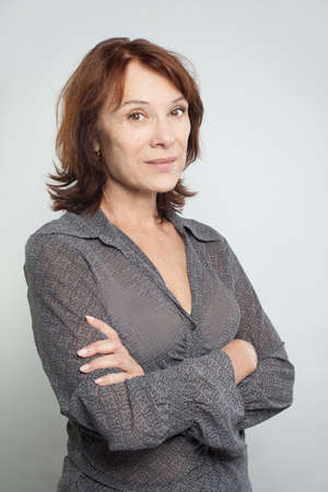 Portrait of mid adult woman with crossed armsの写真素材