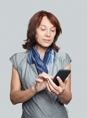 Mature businesswoman using smartphoneの写真素材