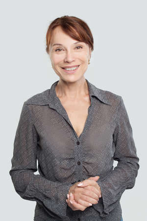 Happy mid adult woman on whiteの写真素材