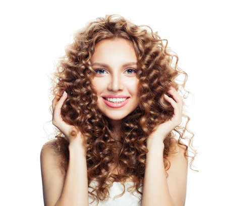 Beautiful female model with healthy skin and curly hair. Friendly blonde womanの写真素材