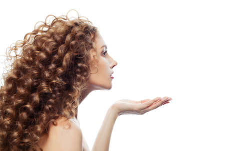 Perfect female model woman with empty copy space on the open hand isolated on whiteの写真素材