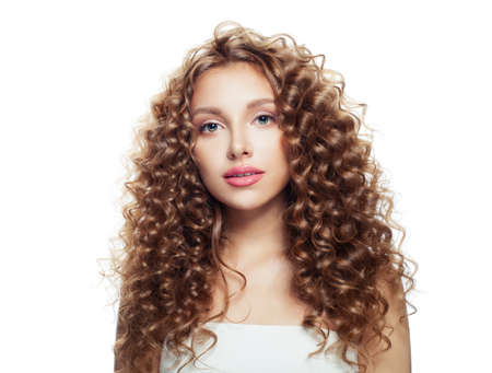 Friendly woman with healthy skin and long curly hair isolated on whiteの写真素材
