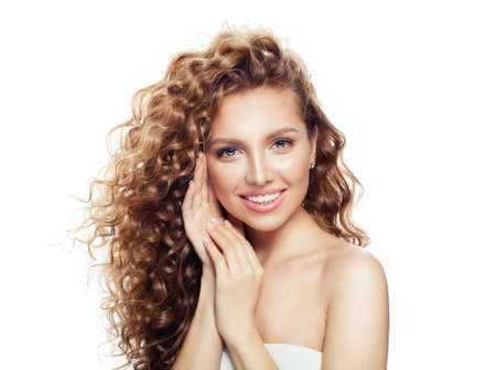 Young woman with healthy skin and blonde curly hair isolated on white.の写真素材
