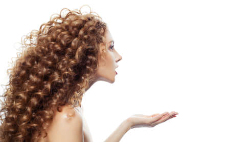 Young blonde woman with long wavy hair isolated on whiteの写真素材