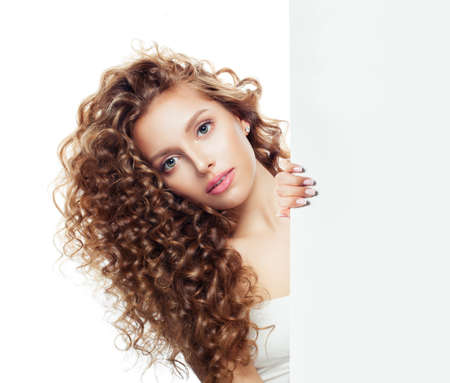Cute woman with white empty paper board  with copy space for advertising marketing or product placementの写真素材