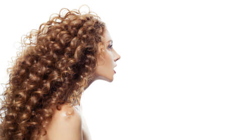 Cute woman with perfect wavy hair isolated on white.の写真素材