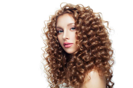Beautiful blonde girl with healthy skin and perfect curly hair isolated on whiteの写真素材