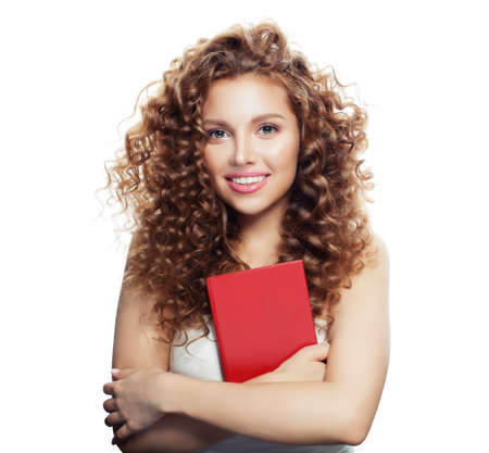 Smiling young woman with book isolated on whiteの写真素材