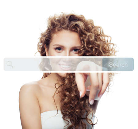 Beautiful young woman pointing to empty address bar in virtual web browser isolated. Seo, internet marketing or distance learning conceptの写真素材