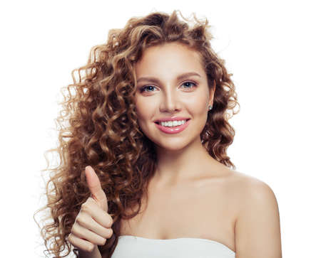 Young smiling woman thumb up isolated on white. Happy girlの写真素材