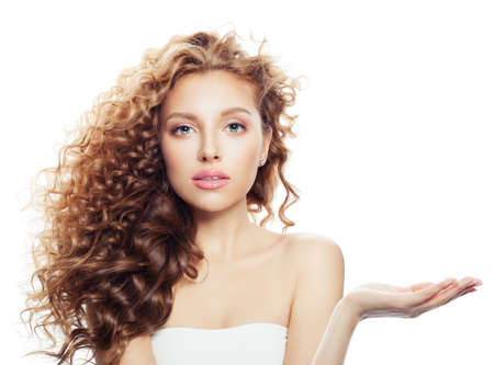 Perfect woman with empty open hand with copy space for advertising marketing or product placement isolated on white backgroundの写真素材