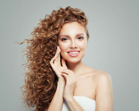 Perfect young woman with cute smile. Beautiful female faceの写真素材