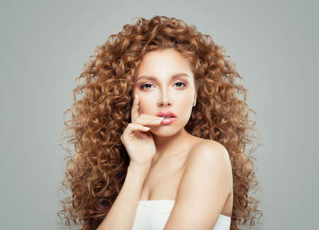 Perfect woman with long healthy curly hair. Redhead girl, haircare conceptの写真素材