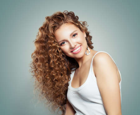 Young woman smiling. Cute girl in white t-shirt portraitの写真素材
