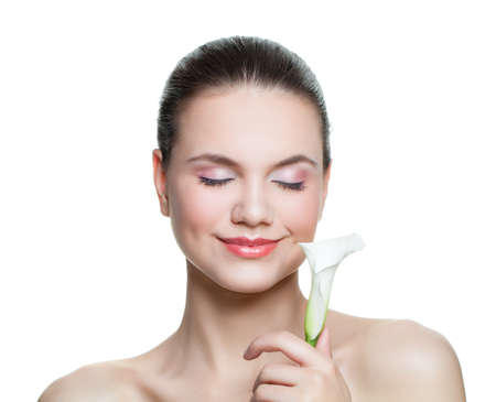 Smiling woman spa model holding flower isolated on whiteの写真素材