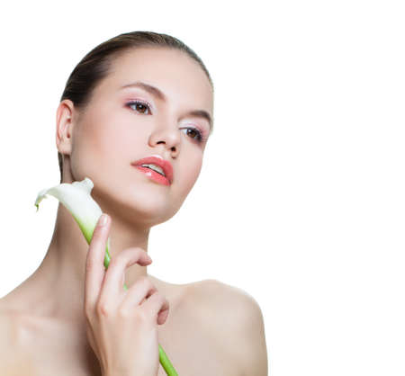 Spa beauty. Beautiful woman with white flower isolated on white. Facial treatment, cosmetology, beauty, skincare and wellnessの写真素材
