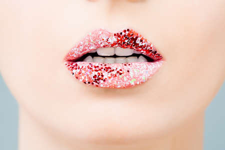 Glossy lips, beautiful makeup with red and pink lipstick. Close up macro beautiful mouthの写真素材