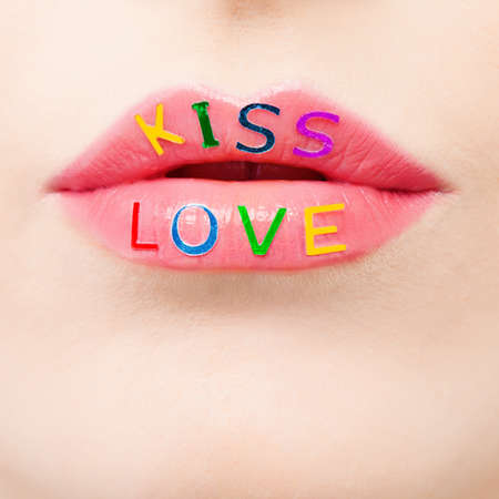 Valentine's day and love concept with beautiful pink lips closeup. Makeup, passion and colorful love signの写真素材