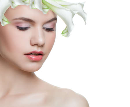Spring woman with white flower isolated on white background. Beautiful face, fresh skinの写真素材
