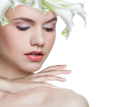 Perfect spring woman isolated. Spa model with white flower isolated on white background. Facial treatment, cosmetology, beauty, skincare and spa conceptの写真素材